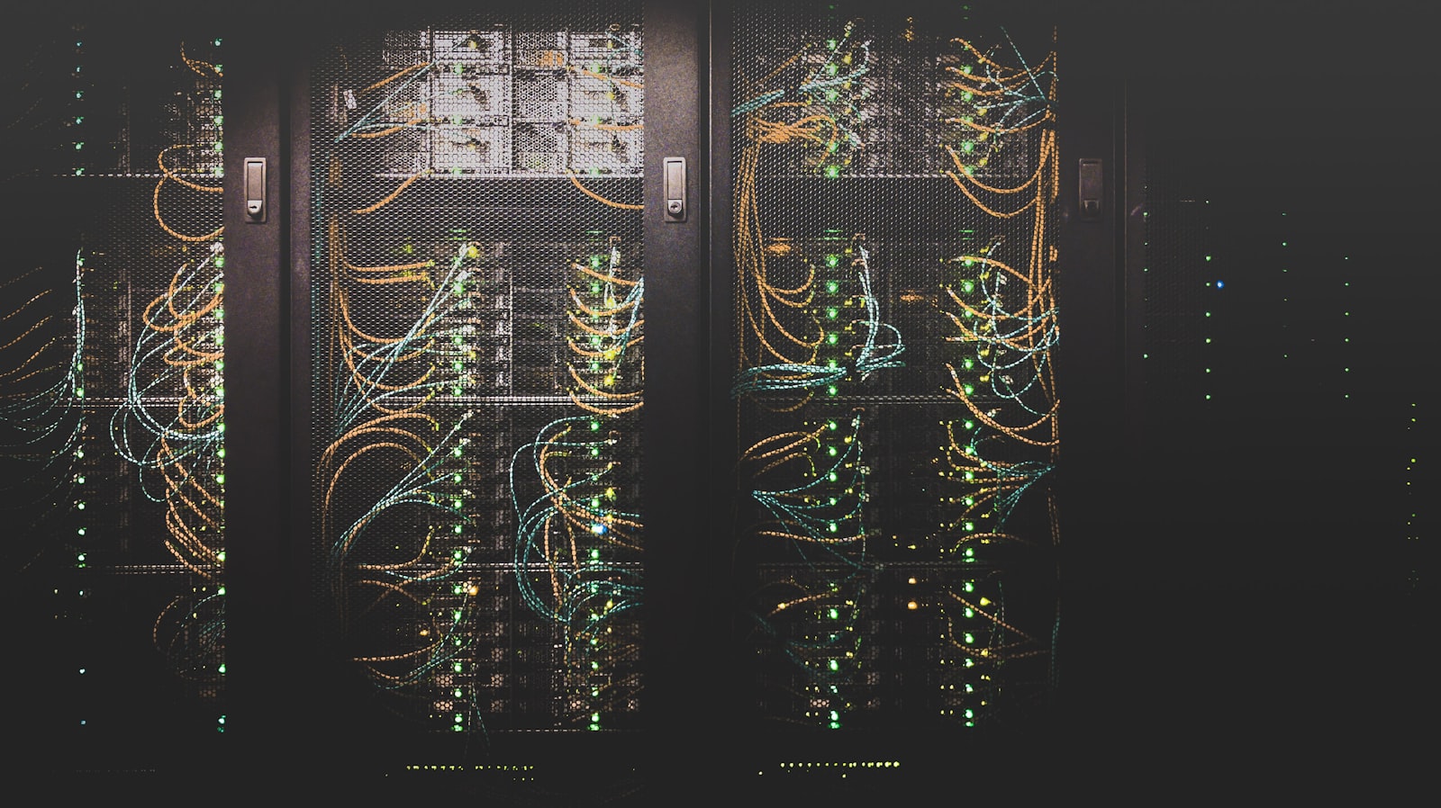 Server room with blue lighting and rows of equipment