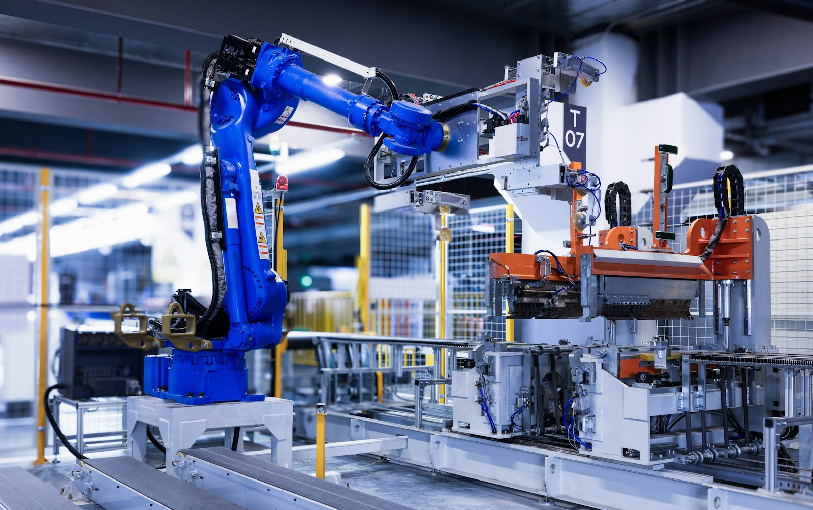 Blue industrial robotic arm on a factory assembly line